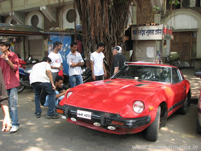 An old Porsche I think the red one seems like an old Porsche and this Chevy 