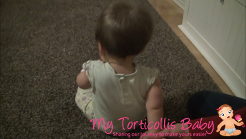 Baby with right torticollis doing a physical therapy stretch.