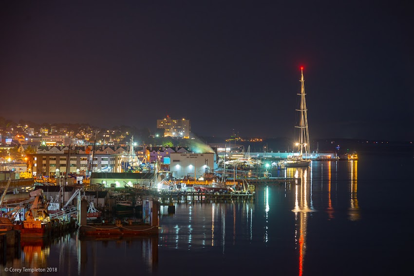 Portland, Maine USA September 2018 photo by Corey Templeton. A view of wharves at night from the Casco Bay Bridge, featuring a glimpse of the "M5," one of the world's largest yachts.