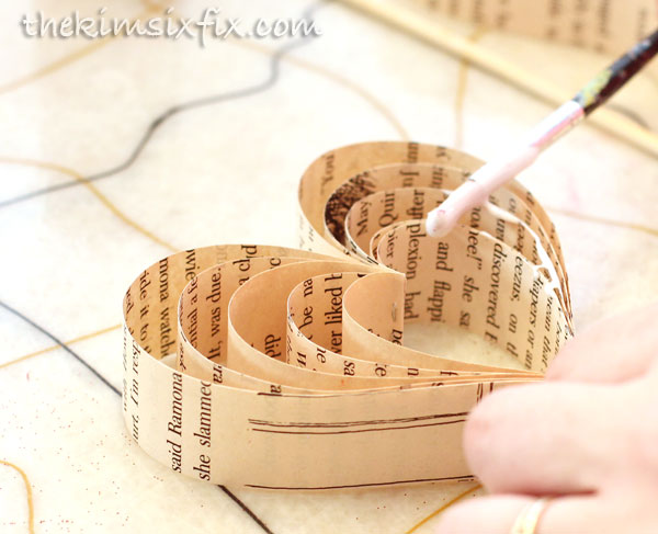 Adding glue to paper heart