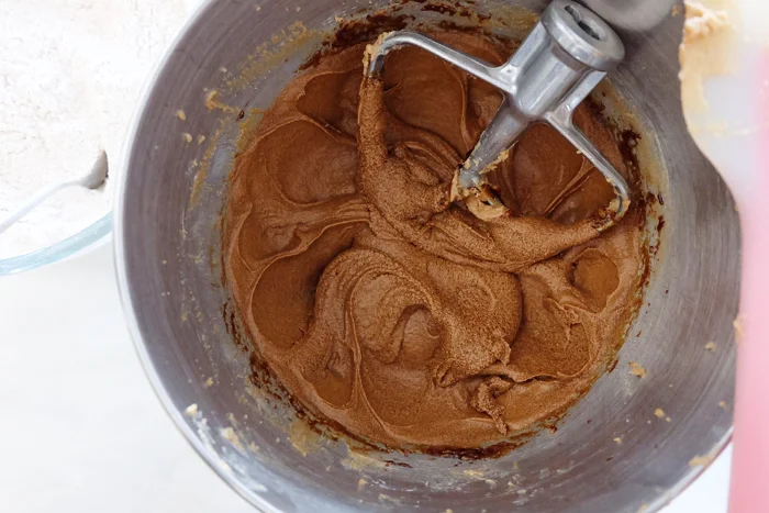 adding molasses to mixer bowl