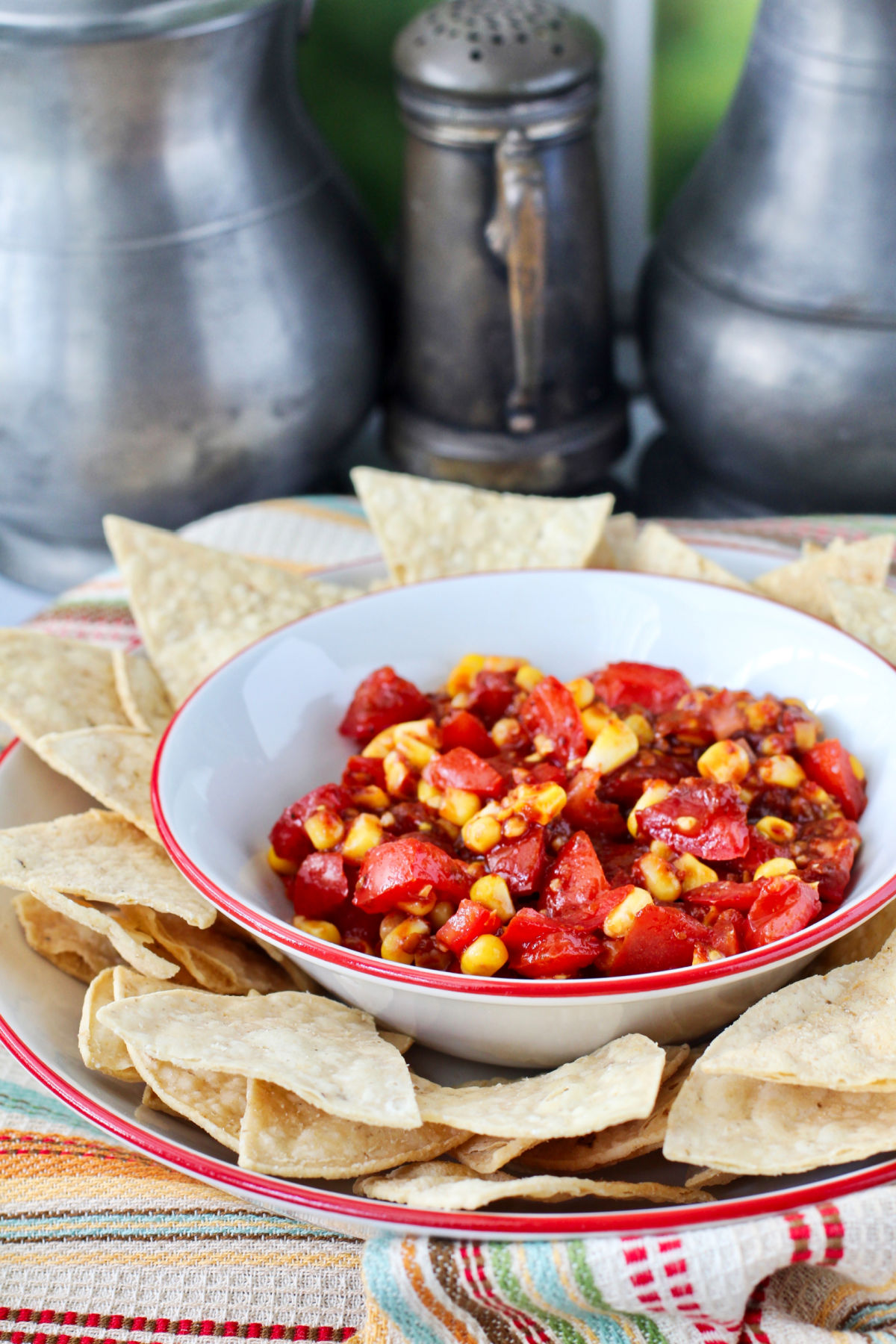 Tomato and Corn Chipotle Salsa with chips in a bowl.