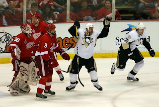 DETROIT - JUNE 02: Ryan Malone #12 and Evgeni Malkin #71 of the Pittsburgh Penguins celebrate after Petr Sykora scored the game winning goal past goaltender Chris Osgood #30, Andreas Lilja #3 and Nicklas Lidstrom #5 of the Detroit Red Wings during game five of the 2008 NHL Stanley Cup Finals at Joe Louis Arena on June 2, 2008 in Detroit, Michigan. The Penguins defeated the Red Wings 4-3 in triple overtime to set the series at 3-2 Red Wings.