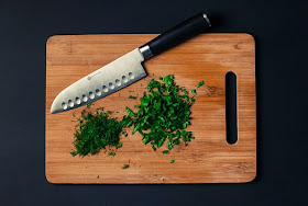 chopping board with diced herbs