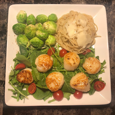 Seared sea scallops, spaghetti with garilc and olive oil and steamed Brussels sprouts