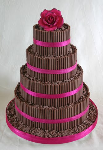 Beautiful dark chocolate curls four tier wedding cake with deep pink satin 