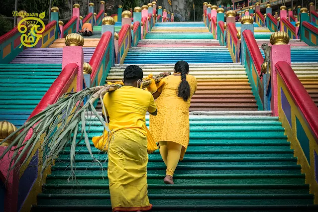 A couple carried their baby up Batu Caves for Thaipusam 2021