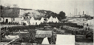 “I would almost rather do anything than ship batteries” pleaded Garrison and view here of U.S. heavy artillery ready for transportation at Yorktown during Peninsular campaign shows why. Big 30-pounder Parrott rifles in background are grouped with quantity of “impedimenta,” such as field forges and ammunition waggons which accompanied gun in the field. Pieces shown probably were included among Garrison’s purchase in 1870 which overflowed from biggest steam freighter afloat. Guns are in travelling position, trunnions unseated and tubes pulled to rear to balance in draught.
