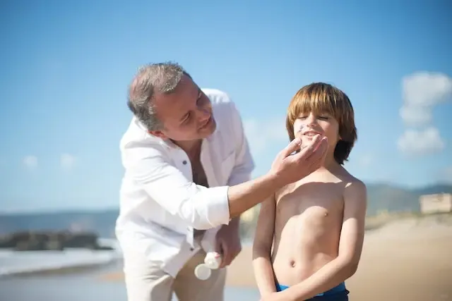 Boy applying sunscreen Boy applying sunscreen