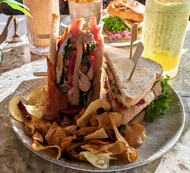 a plate of food with a sandwich and crisps