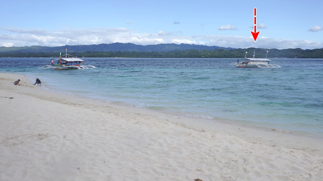 boats departing from and arriving at the beach of Canigao Island, Matalom Leyte