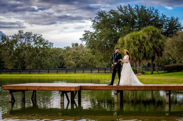 bride and groom on lake dock