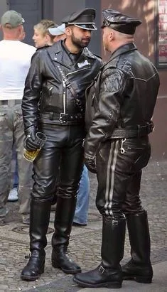 Leathermen facing each other at a street fair swooning in full gear