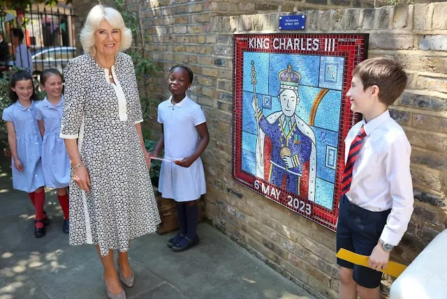 Queen Camilla wore a flower print dress. Queen Camilla visited Christ Church Primary School's Literary Festival