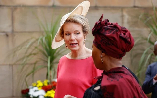 Queen Mathilde wore a fuchsia pink cape silk dress by Natan. President Cyril Ramaphosa and Minister Lindiwe Zulu