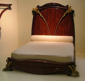 A mahogany bed, known as the Nénuphar bed for its water lily motifs, designed and manufactured by Louis Majorelle around 1902-3, on display at the Musée d'Orsay, Paris