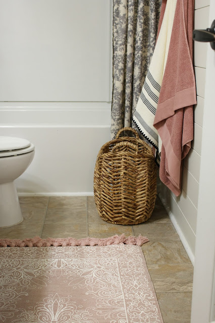 Use a small basket instead of a hamper in a small bathroom