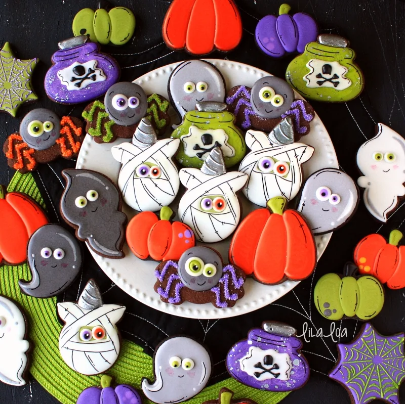 Halloween decorated chocolate sugar cookies -- spiders, ghosts, pumpkins, mummy unicorns and potion bottles