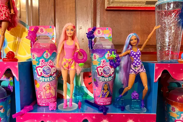 Barbie Pop Reveal dolls next to their packaging