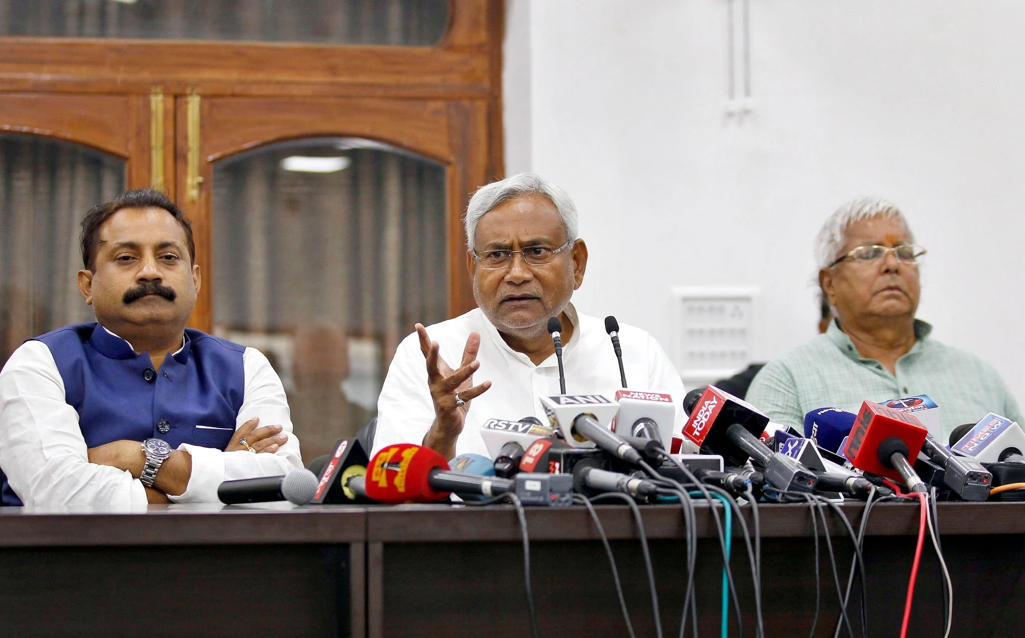 Janata Dal-United (JD-U) leader Nitish Kumar (C) and Rashtriya Janta Dal leader Lalu Prasad Yadav and Ashok Choudhary (R), President of the Bihar Pradesh Congress Committee, during a press conference after landslide victory in Bihar Assembly elections at Nitish Kumar's residence, on November 8, 2015 in Patna, India.