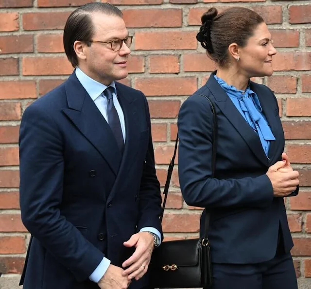 Crown Princess Victoria wore a navy suit, blazer and pants, by Tiger of Sweden, and an Irina blue frilled tie blouse by Mayla Stockholm