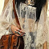Bohemian stylish pure hard leather bag and lace shirt with big rings on both hands 