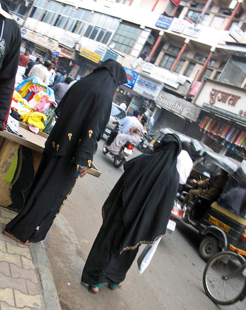 burkha clad women on a busy road