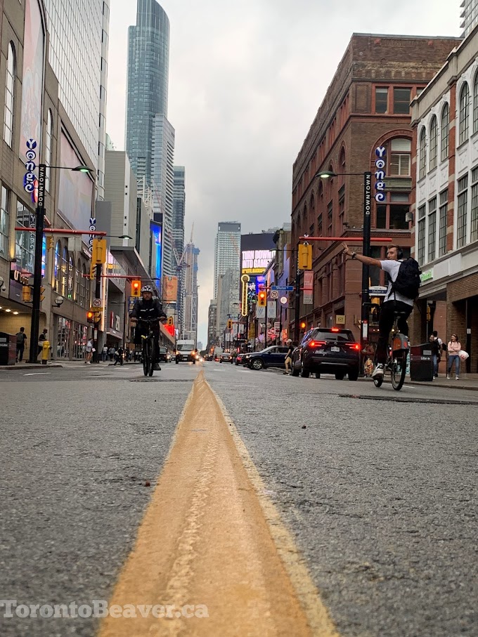 Human Bicyclist Flashes The Peace Sign On Yonge Street Downtown
