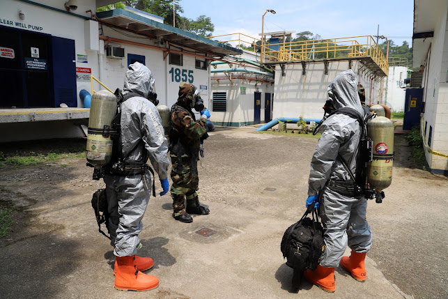 Combined bomb personnel of the Philippine Army and Philippine National Police in hazardous material protection suits perform radiation-tracking procedures during a mock biological terrorism attack held at Subicwater-Binictican Treatment Facility in Subic Bay Freeport zone.