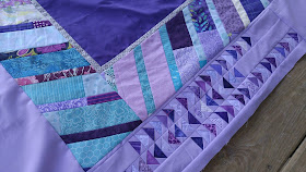 purple and aqua feather round robin quilt