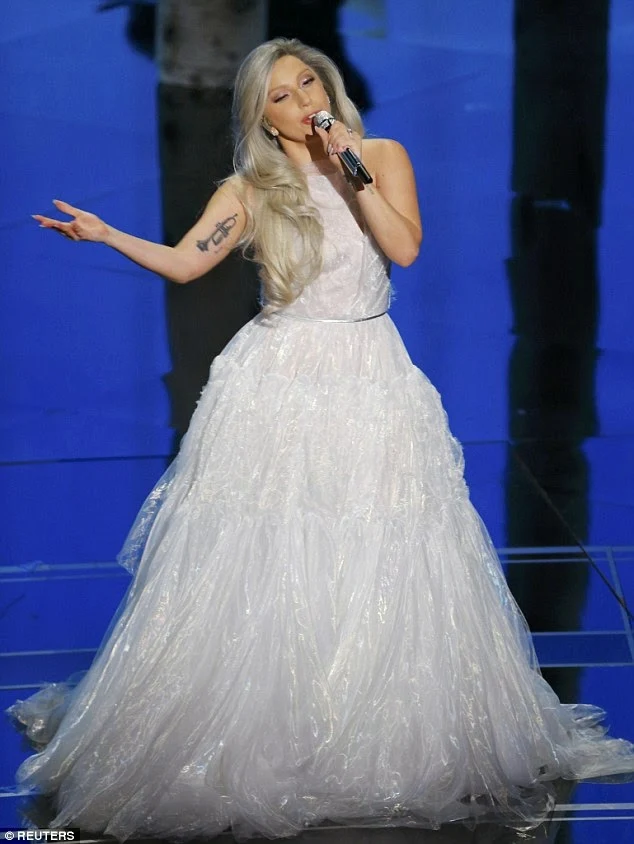 Lady Gaga performs in a bridal inspired gown at the 2015 Oscars in Hollywood