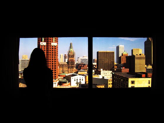 A view from the Hyatt of downtown Milwaukee and a girl's silhouette.