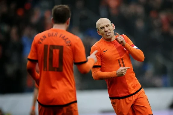 Arjen Robben celebrates his goal against Japan with Netherlands teammate Rafael van der Vaart