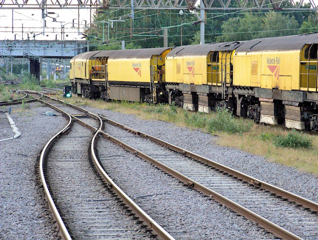 Photo Network Rail Loram C21 Rail Grinder Train 'Roger South' Slowly Begins to Make It's Way Out Of Northampton Station Sidings 2000s