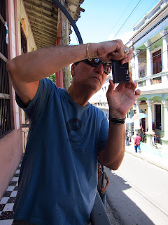 Santiago de Cuba Pedro photographing from a balcony