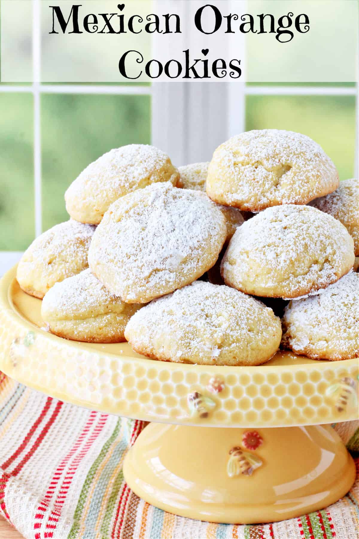 Polvorones de Naranja -  Triple Orange Mexican Cookies on a cake stand.