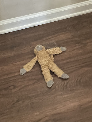 Monkey splayed out on the floor.