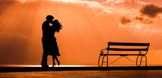 Photo showing a silhouette of a couple kissing