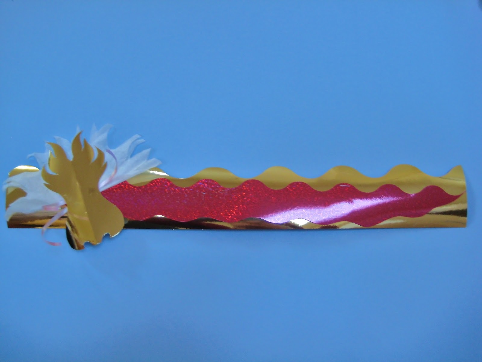 Fold the thin border paper in half. Cut. This will be your dragon's ...