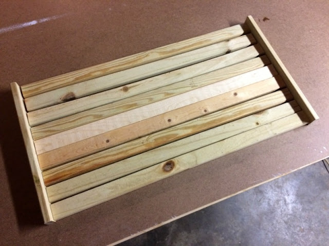 We used a large plastic tray and scrap wood to make a drying tray for our shoes and boots.