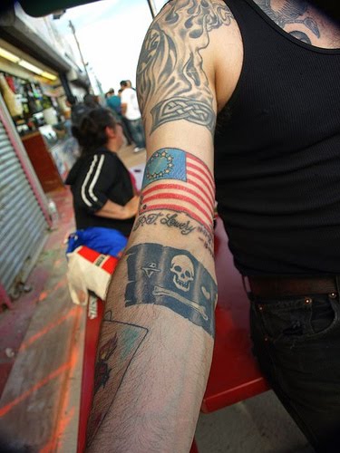 Pirate flag tattoo on inner forearm