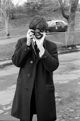 black and white photograph by Bill Eppridge of Paul McCartny with a camera held to his eye, 1964