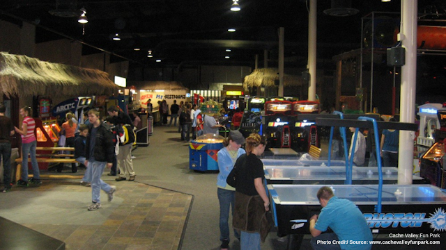 visitors playing arcade games and air hockey