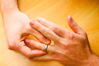 man twirling wedding ring