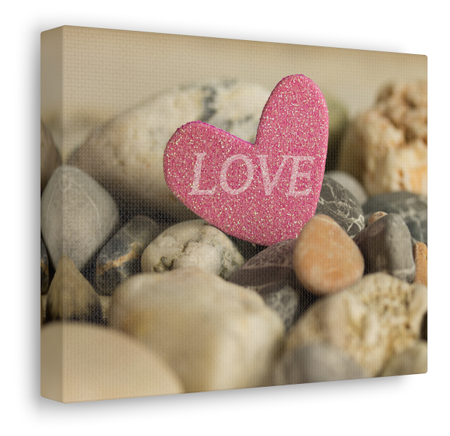 Valentine Canvas Gallery Wrap With a Pink Heart and The Text LOVE Laying Between Stones