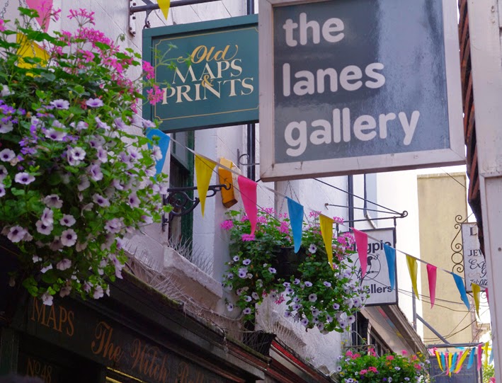 brighton small streets signs and flowers hanging