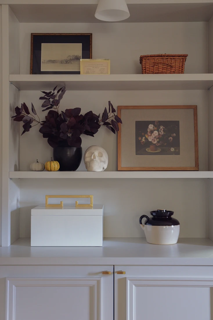 bookcase styled with fall decor accessories