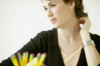 woman; white woman; sitting at a desk