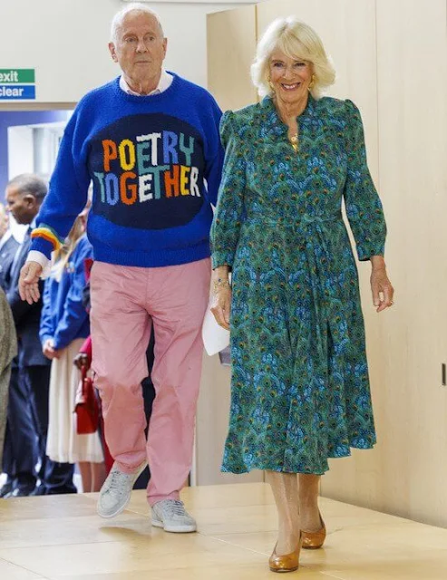 Queen Camilla wore a peacock-patterned dress by Liberty of London. Poetry Together was launched by Gyles Brandreth