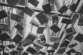 Floating books in the air, black and white, tied to strings